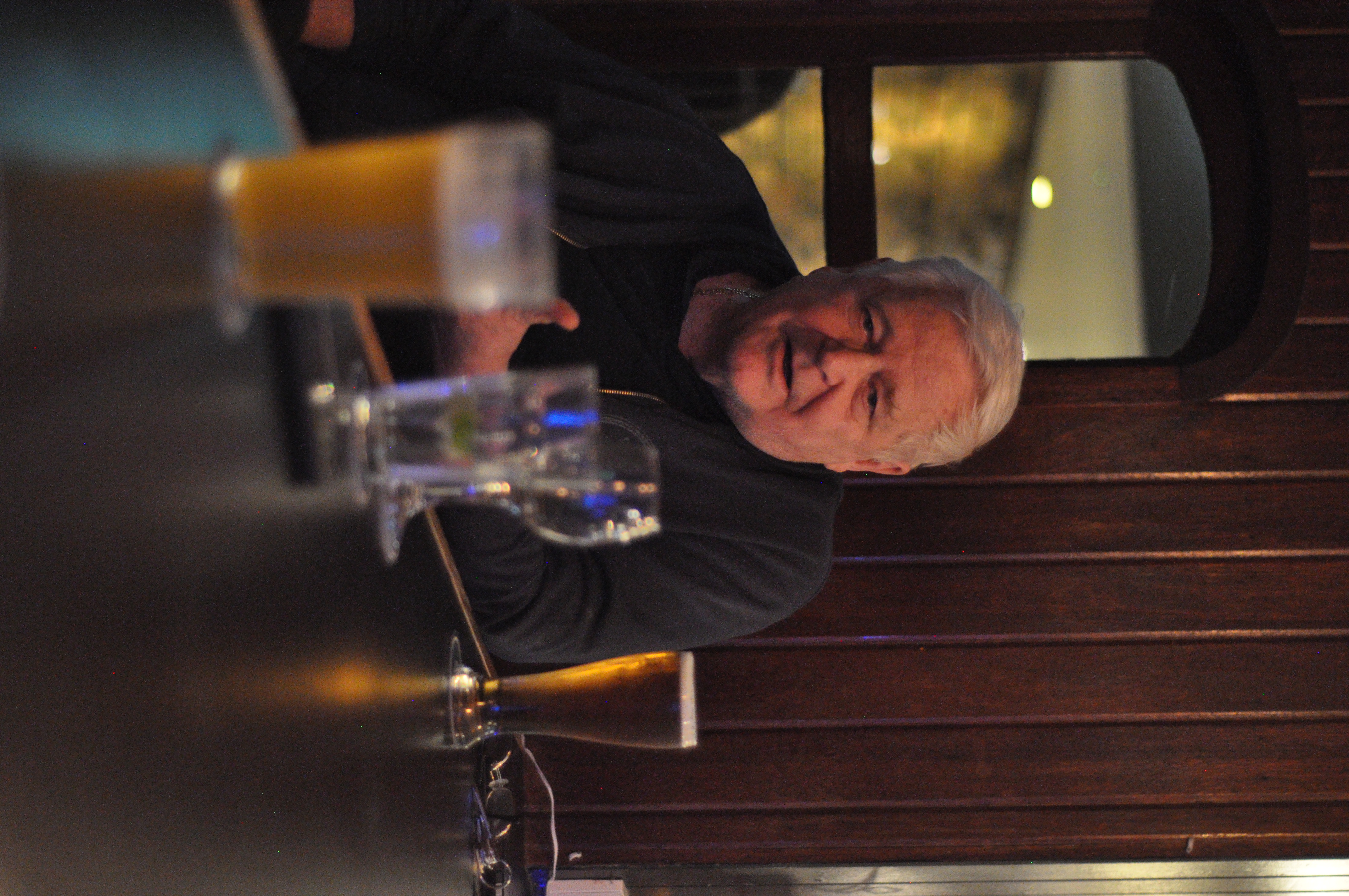 Candid portrait of a man seated at a pub table
